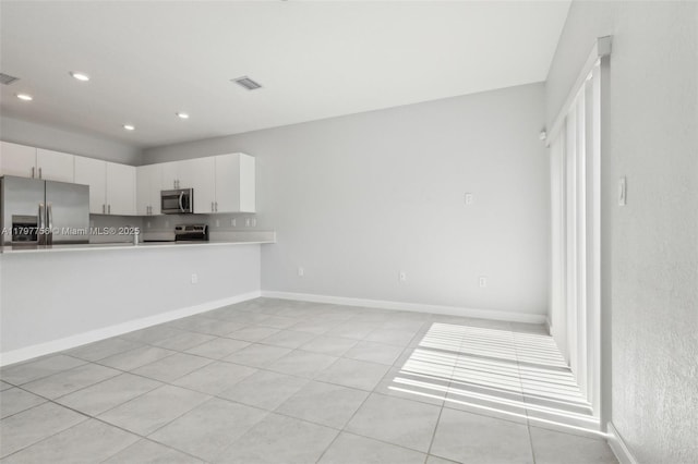 28625 SW 132nd Ct, Homestead, FL 33033 - kitchen featuring stainless steel appliances, light countertops, recessed lighting, white cabinetry, and light tile patterned floors