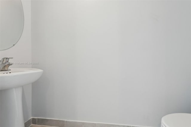 28625 SW 132nd Ct, Homestead, FL 33033 - bathroom with baseboards, toilet, a sink, and tile patterned flooring