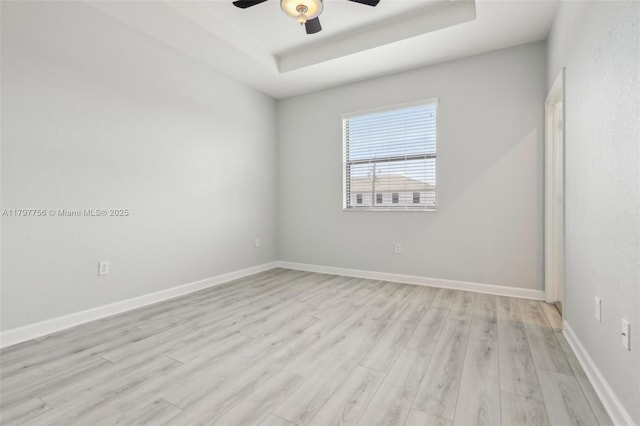 28625 SW 132nd Ct, Homestead, FL 33033 - spare room featuring a raised ceiling, a ceiling fan, light wood finished floors, and baseboards