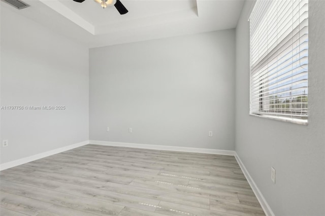 28625 SW 132nd Ct, Homestead, FL 33033 - empty room with a tray ceiling, a ceiling fan, light wood-style flooring, and baseboards