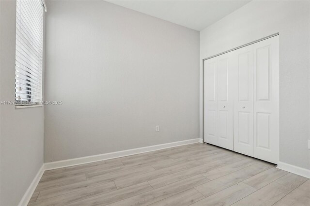 28625 SW 132nd Ct, Homestead, FL 33033 - unfurnished bedroom featuring light wood finished floors, a closet, and baseboards