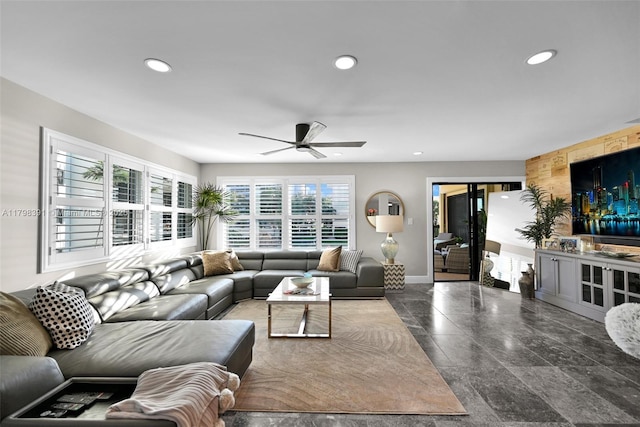 living area featuring recessed lighting, a ceiling fan, and baseboards