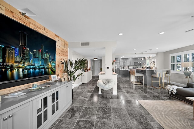 living room featuring baseboards and recessed lighting
