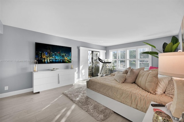 bedroom featuring baseboards and wood finished floors
