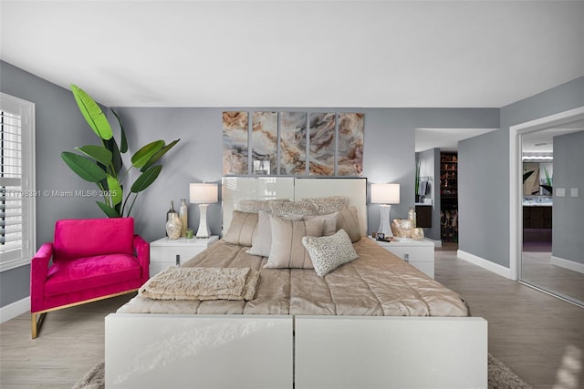 bedroom with wood finished floors and baseboards