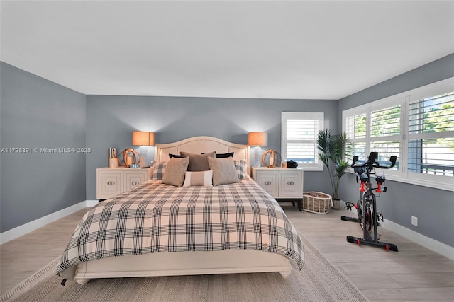 bedroom with light wood-style floors and baseboards