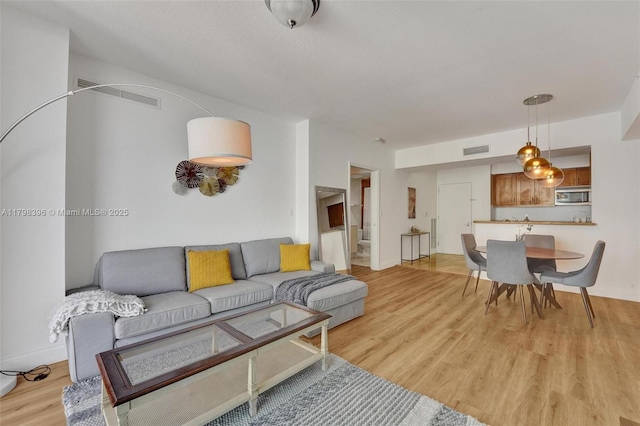 living room with light wood-style floors and baseboards