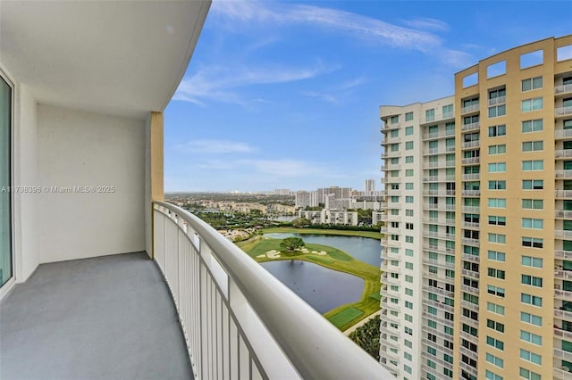 balcony with a water view, a view of city, and view of golf course