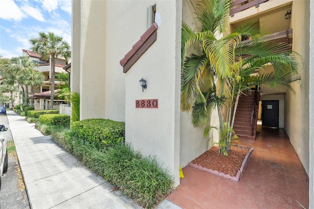 entrance to property featuring stucco siding