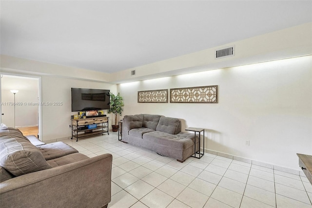 living area with light tile patterned floors and baseboards