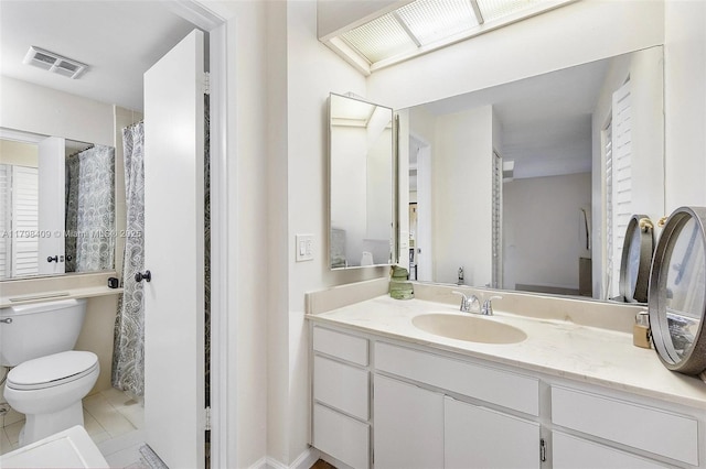 full bath featuring toilet, vanity, and tile patterned floors