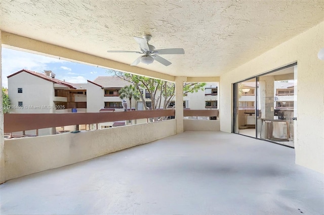 view of patio featuring ceiling fan and a balcony