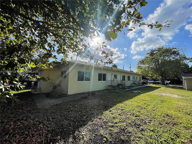8321 NE Miami Ct, Miami, FL 33138 - view of property exterior featuring stucco siding and a yard