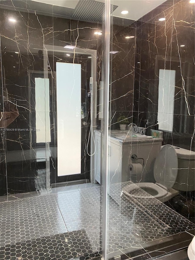 full bath featuring tile walls and a marble finish shower