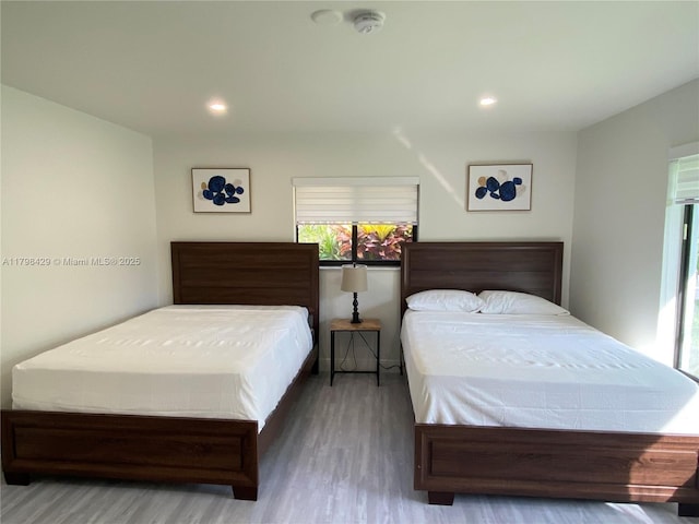 bedroom with wood finished floors and recessed lighting