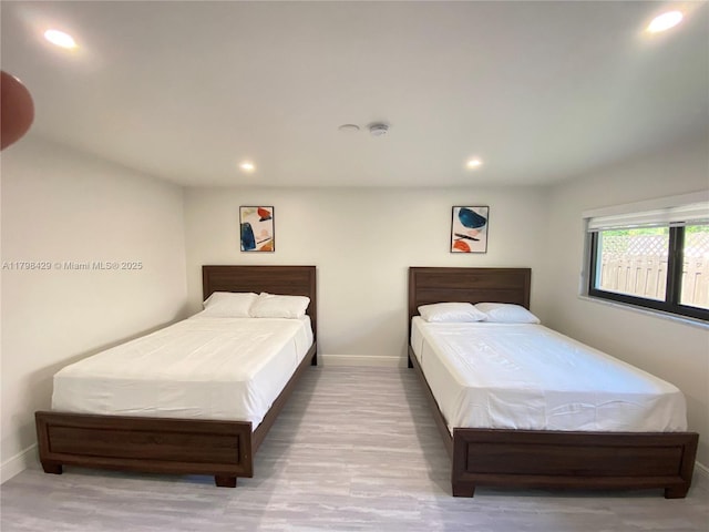 bedroom with recessed lighting, baseboards, and wood finished floors