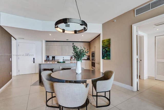 dining space featuring light tile patterned flooring and baseboards