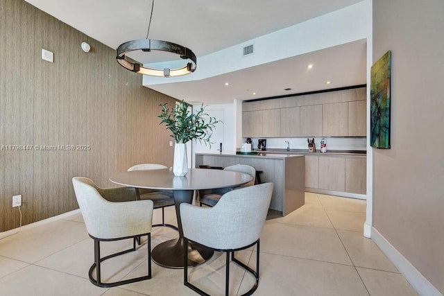 dining room with light tile patterned floors and baseboards