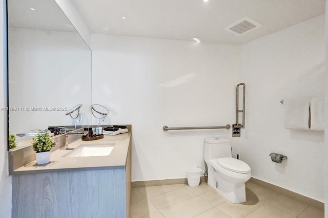 bathroom with toilet, baseboards, vanity, and tile patterned floors