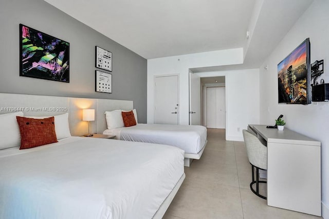 bedroom with light tile patterned floors