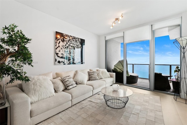 living room with expansive windows and light tile patterned floors