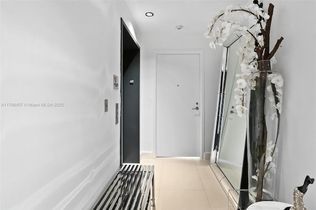hall with tile patterned floors and baseboards