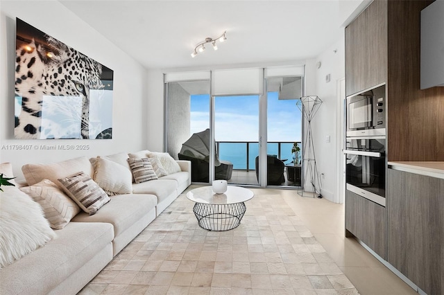 living area with light tile patterned floors and floor to ceiling windows