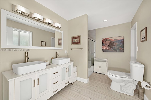 2221 N 46th Ave, Hollywood, FL 33021 - bathroom featuring toilet, baseboards, recessed lighting, double vanity, and bath / shower combo with glass door