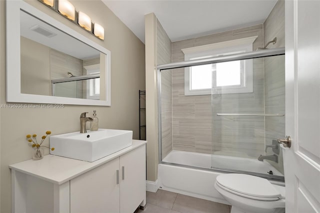 2221 N 46th Ave, Hollywood, FL 33021 - bathroom with combined bath / shower with glass door, tile patterned flooring, toilet, and vanity