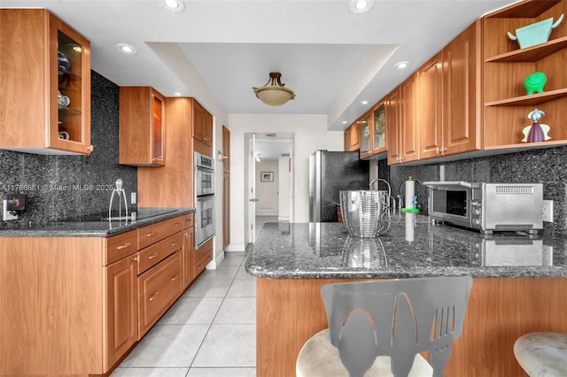 11 Island Ave Unit 512, Miami Beach, FL 33139 - kitchen featuring appliances with stainless steel finishes, light tile patterned flooring, open shelves, glass insert cabinets, and recessed lighting