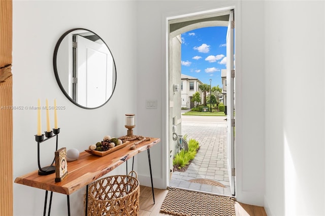 entryway featuring light wood-style floors and baseboards