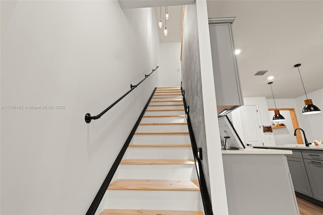 staircase with wood finished floors