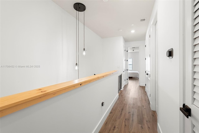hall with wood finished floors and baseboards