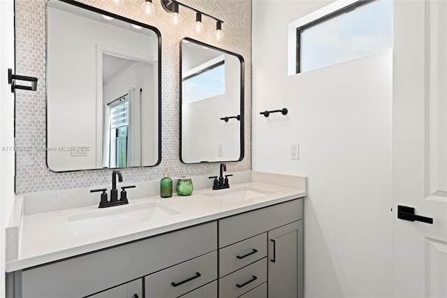 bathroom featuring healthy amount of natural light and double vanity