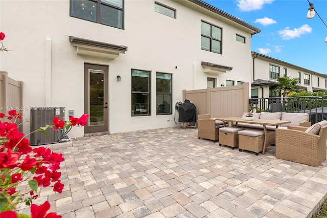 view of patio / terrace featuring fence, outdoor lounge area, and cooling unit