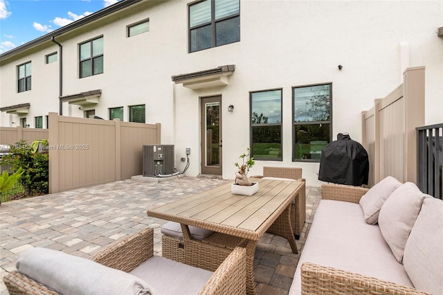 view of patio with central air condition unit, fence, an outdoor living space, and grilling area