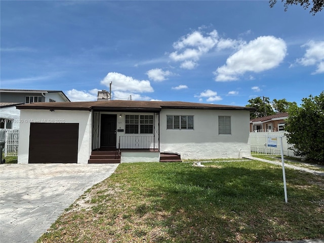 6211 NW 37th Ter, Virginia Gardens, FL 33166 - view of front facade with an attached garage, stucco siding, and decorative driveway
