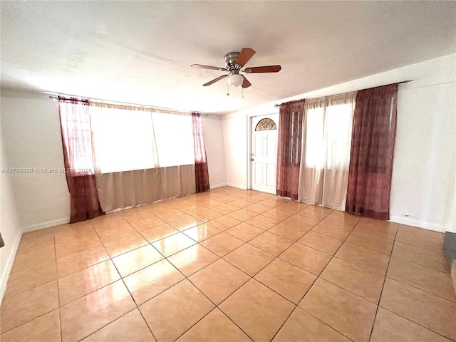 6211 NW 37th Ter, Virginia Gardens, FL 33166 - empty room featuring a ceiling fan, light tile patterned floors, and baseboards