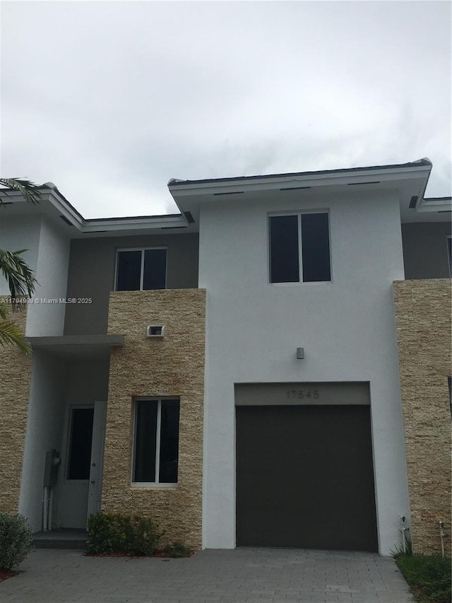 17545 SW 150th Ct, Miami, FL 33187 - view of front of home featuring stucco siding, an attached garage, driveway, and stone siding