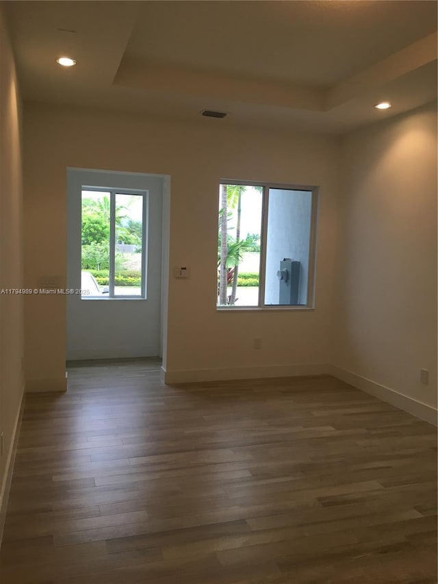 17545 SW 150th Ct, Miami, FL 33187 - spare room featuring a raised ceiling, wood finished floors, baseboards, and recessed lighting
