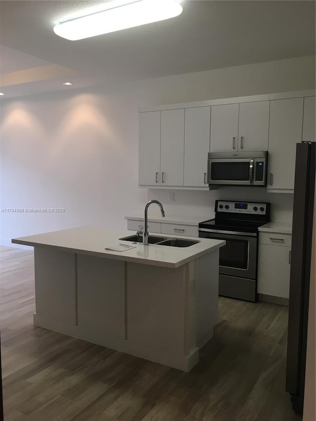 17545 SW 150th Ct, Miami, FL 33187 - kitchen featuring appliances with stainless steel finishes, a sink, dark wood finished floors, and light countertops