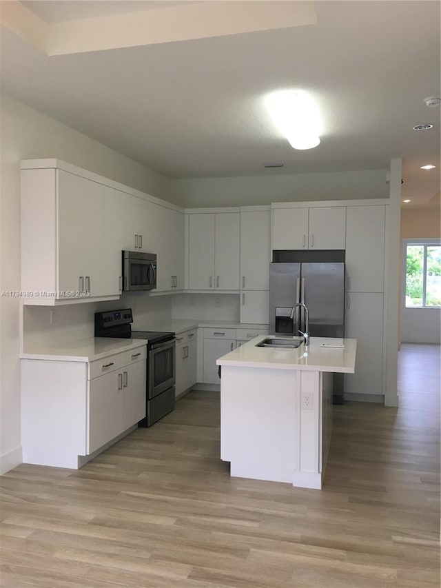 17545 SW 150th Ct, Miami, FL 33187 - kitchen featuring stainless steel appliances, a sink, light wood-style flooring, light countertops, and recessed lighting
