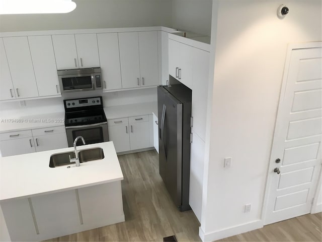 17545 SW 150th Ct, Miami, FL 33187 - kitchen with appliances with stainless steel finishes, a sink, light wood-style flooring, and light countertops