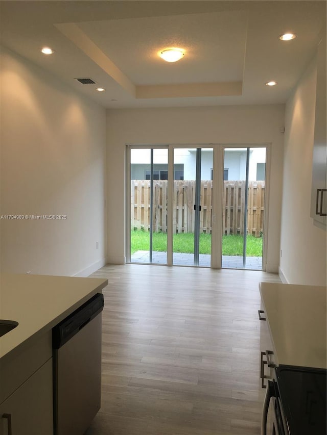17545 SW 150th Ct, Miami, FL 33187 - hallway featuring plenty of natural light, a raised ceiling, light wood-type flooring, baseboards, and recessed lighting