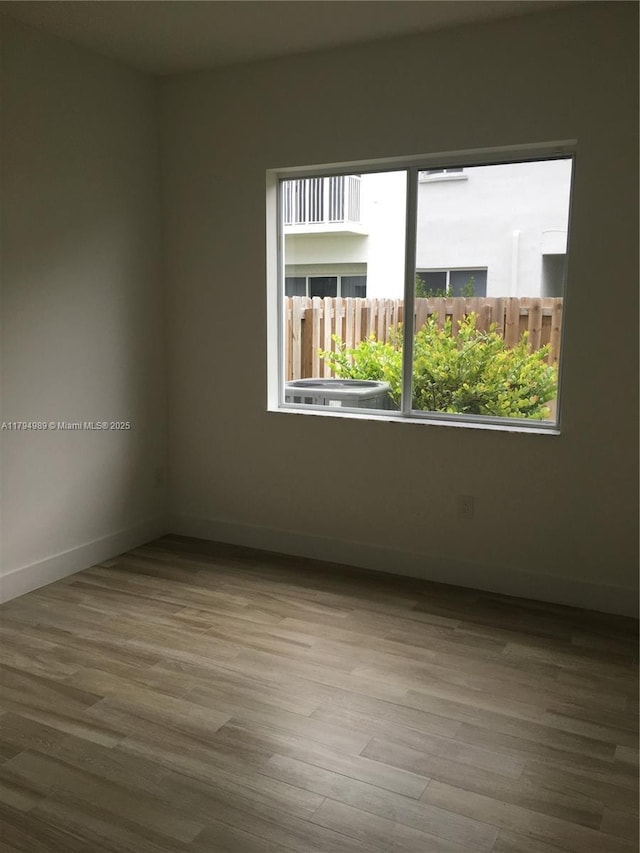 17545 SW 150th Ct, Miami, FL 33187 - unfurnished room featuring baseboards and wood finished floors