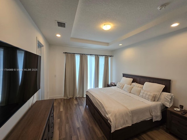 17545 SW 150th Ct, Miami, FL 33187 - bedroom with dark wood-style floors, a raised ceiling, a textured ceiling, recessed lighting, and baseboards