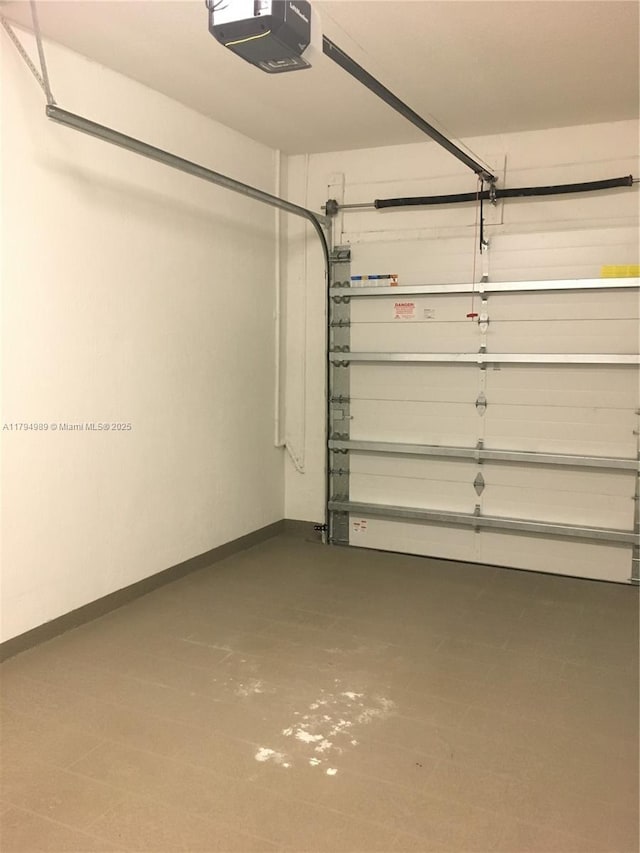 17545 SW 150th Ct, Miami, FL 33187 - garage with a garage door opener and baseboards