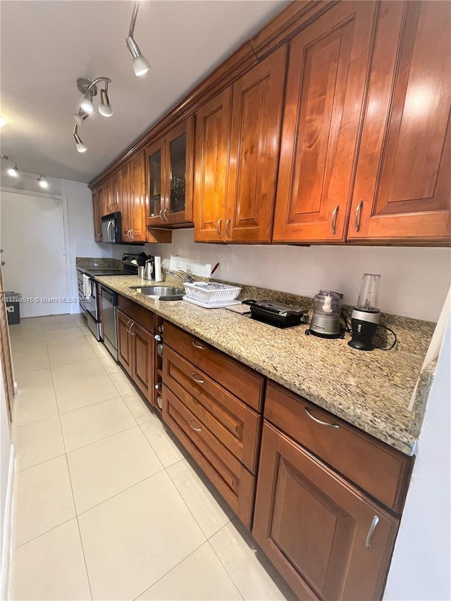 3660 NE 166th St Unit 307, North Miami Beach, FL 33160 - kitchen featuring black appliances, light tile patterned flooring, and light stone countertops