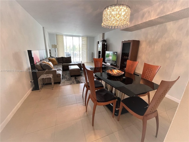 3660 NE 166th St Unit 307, North Miami Beach, FL 33160 - dining space with baseboards, a chandelier, and light tile patterned floors