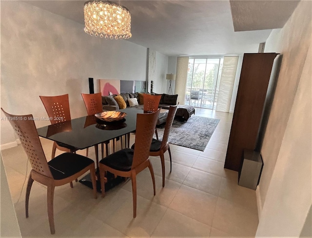 3660 NE 166th St Unit 307, North Miami Beach, FL 33160 - dining space featuring a chandelier, light tile patterned floors, and expansive windows